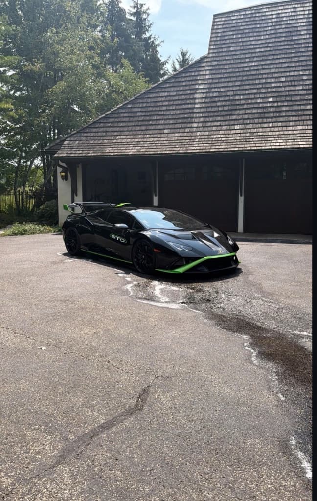 Black Lamborghini Huracán detailed and ceramic-protected by BK Mobile Detailing in a client's driveway