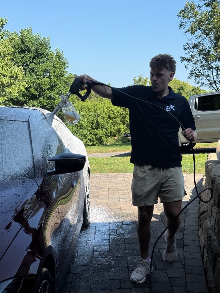 Foam cannon pre-wash covering a car in thick foam before coating prep